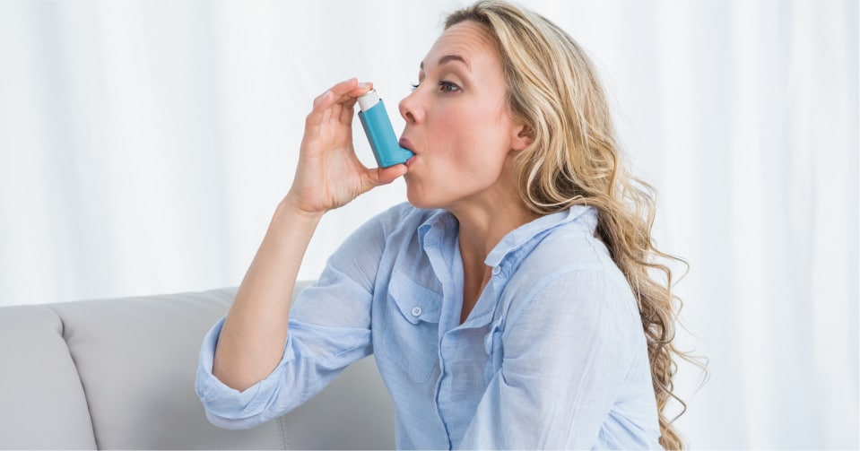 Woman using an inhaler