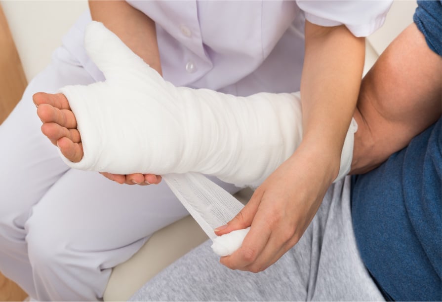 Licensed nurse bandaging the patient's arm