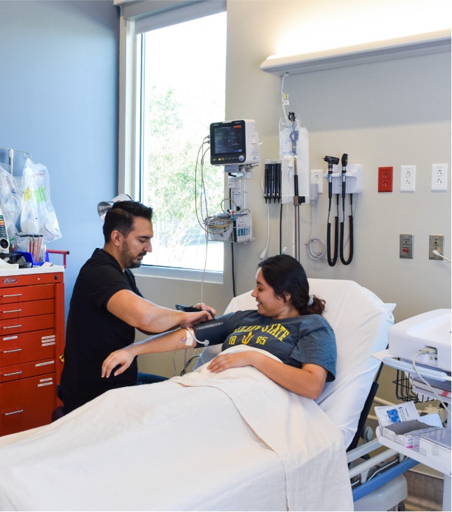 ER nurse checking vitals with an Electrocardiogram (ECG or EKG) Machine