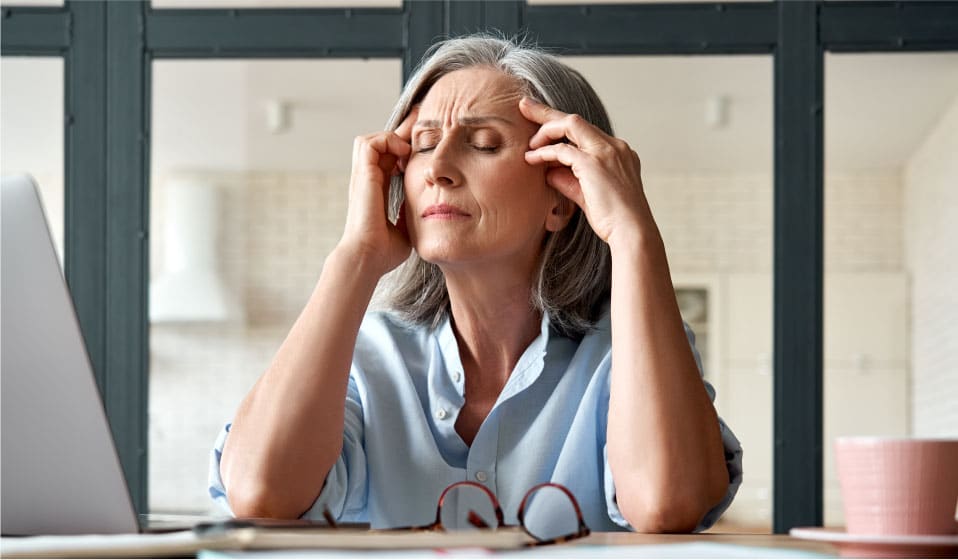 Elderly Woman Suffering From Migraine